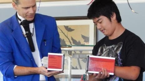 A big kid helps a magician perform a funny-looking mini illusion!