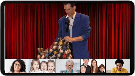 Laughing and smiling, children and adults, watching a virtual magic show.