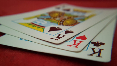Kids learn a card trick from a real live magician during a video chat.