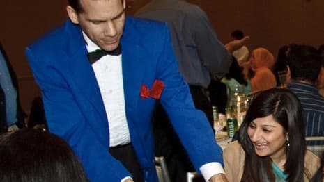 Women smile in reaction to Chicago area table-side magic performance.